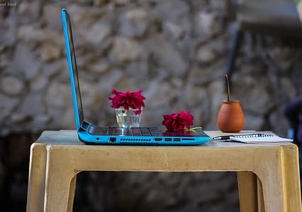Blue Laptop Computer On Brown Plastic Table thumbnail