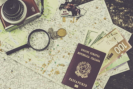 brown passport book placed near magnifying glass thumbnail