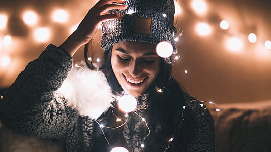 bokeh photography of woman wrapped with string lights thumbnail