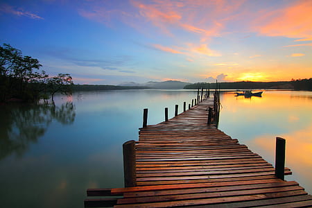 brown wooden sea dock during golden hour thumbnail