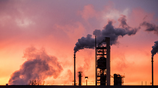 factory blowing smoke during golden hour thumbnail