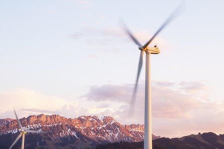 spinning windmill under white sky at daytime thumbnail
