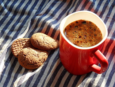 coffee in red and white ceramic mug near three cookies thumbnail