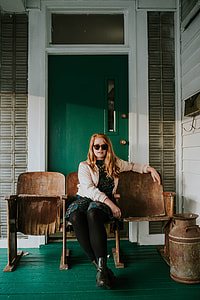 woman wearing beige cardigan sitting on brown armchair thumbnail