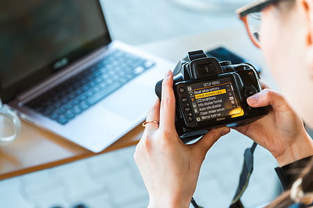 Photographer changes settings his DSLR camera at the modern office thumbnail