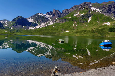 calm body of water near mountains thumbnail