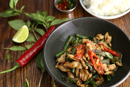 vegetable dish on gray bowl beside red chili thumbnail