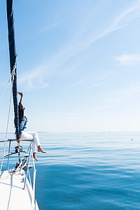 woman sitting on the rail of the boat thumbnail