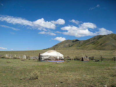 white tent near hills during daytime thumbnail