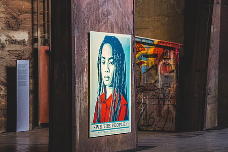 We The People poster on brown pillar thumbnail