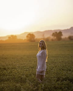 woman wearing white dress on grass field thumbnail