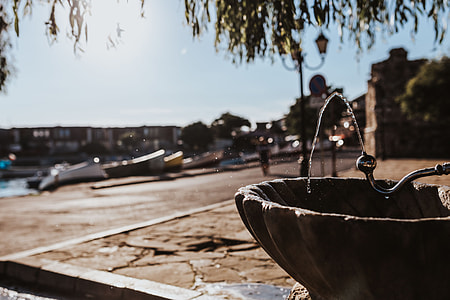 Drinking fountain with stream of water on the sidewalk thumbnail