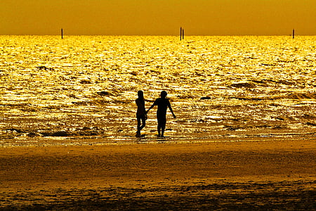 silhouette photography of two person at beach side thumbnail