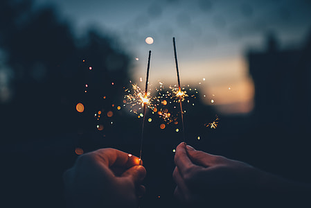 two persons holding firework sticks thumbnail