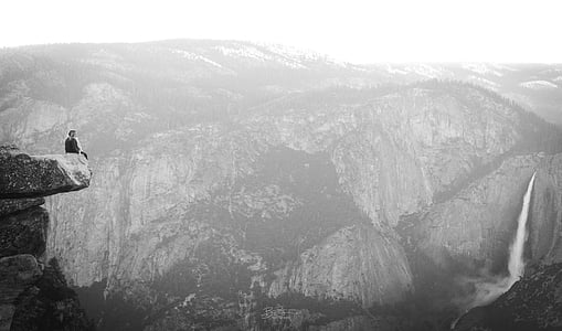 person sitting on rock formation thumbnail