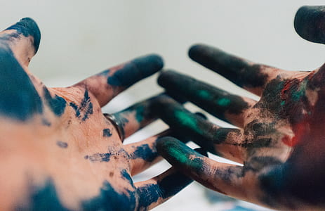 shallow focus photography of person hand with paint thumbnail