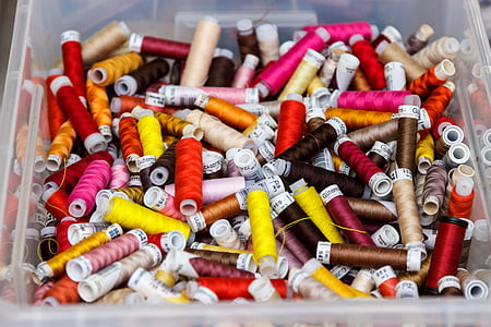 assorted-color threads on plastic container thumbnail