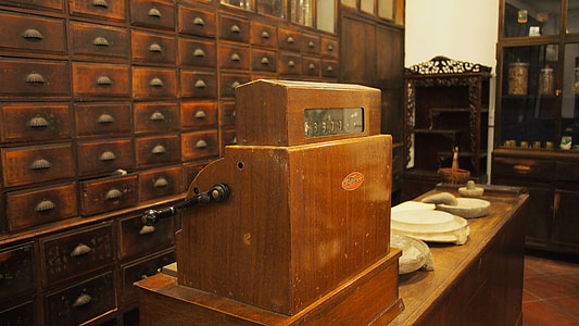 brown wooden cash registry on table inside room thumbnail
