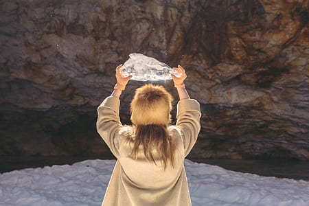 woman standing holding stone in front of stone thumbnail