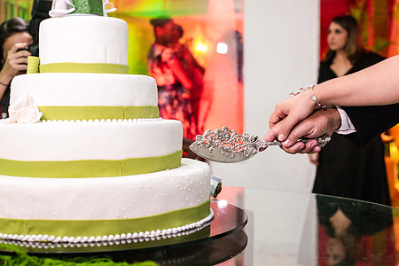 bride and groom holding the cake slicer thumbnail
