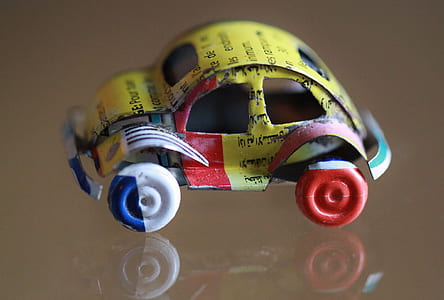 close-up photo of yellow and multicolored Volkswagen Beetle coupe scale model thumbnail