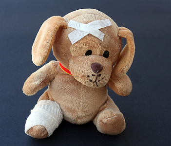 brown dog plush toy on black background thumbnail