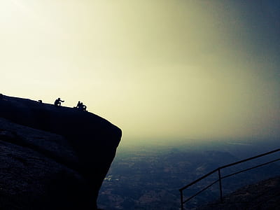 people near the edge of the cliff during day thumbnail