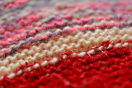 close-up red, pink, and beige knitted textile thumbnail
