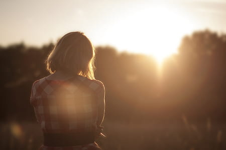 woman in red and white checkered shirt standing during sun rise thumbnail