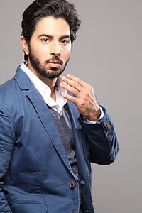 Man About to Touch His Face Wearing Blue Suit thumbnail