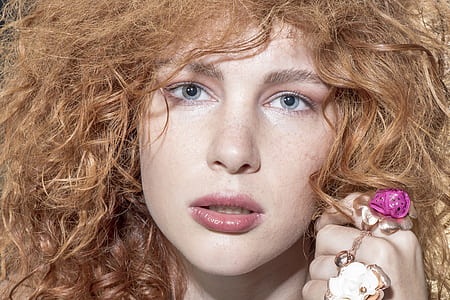 curly blonde-haired woman with pink lipstick thumbnail