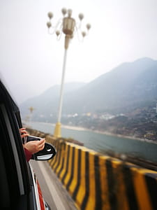 vehicle on road beside water thumbnail
