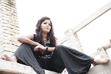 woman sitting on concrete building thumbnail