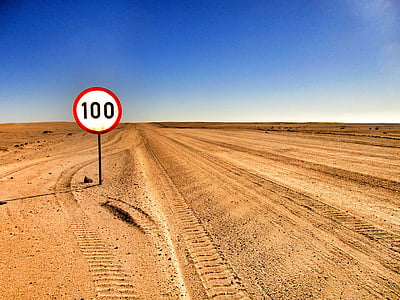 100 road sign on desert thumbnail