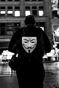 grayscale photography of man carrying backpack thumbnail