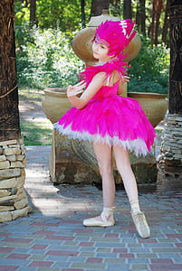 woman wearing pink costume standing near brown tree thumbnail