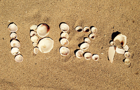 shell letter arrangement on sand thumbnail