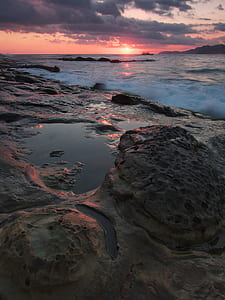 Gray and Black Rock Formation Near the Ocean during Sunset thumbnail