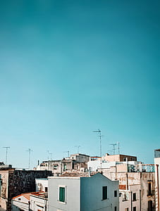 gray concrete building beside white concrete building thumbnail