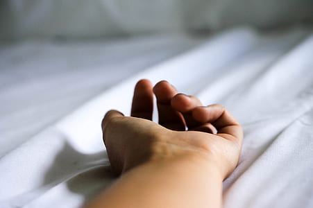 left human hand on white textile thumbnail