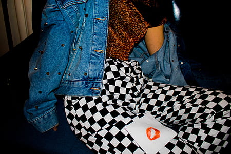 person wearing blue denim jacket and white-and-black checked pants thumbnail