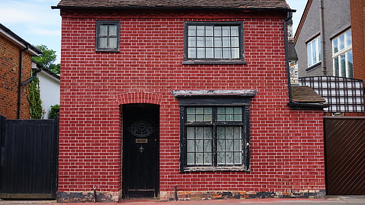 2-storey red brick house during daytime thumbnail