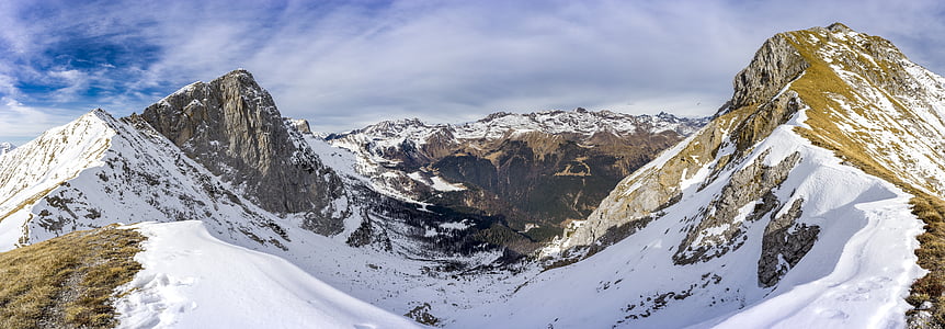 white and brown mountains under cloudy clouds thumbnail