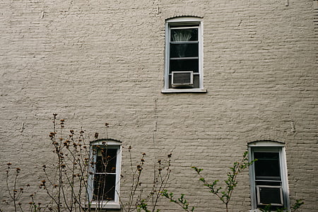 two white window-type AC's on glass windows thumbnail