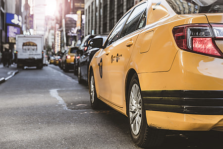 yellow sedan on grey tap road thumbnail