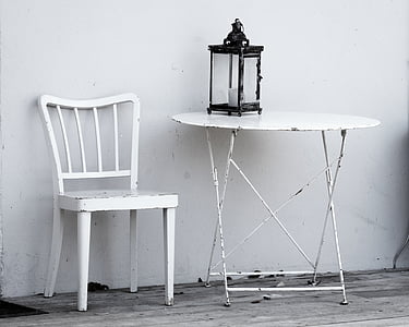 white wooden chair beside round table thumbnail
