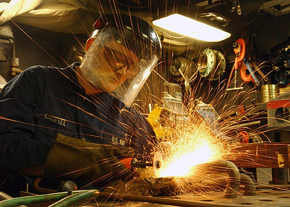 man wearing white welding helmet while welding pipe thumbnail