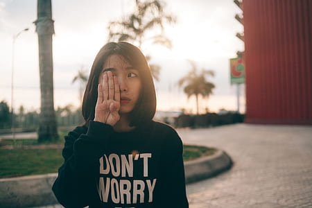 Woman Covering Her Right Eye Using Her Right Hand during Daytime thumbnail