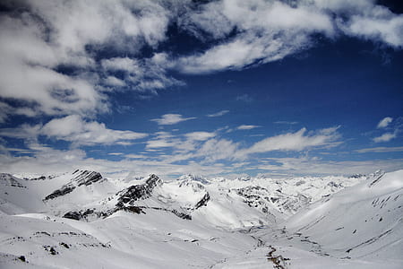 snow covered mountains under blue sky thumbnail