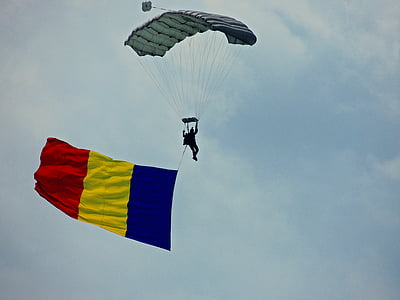 man in flight using air glider while carrying flag of Belgium thumbnail